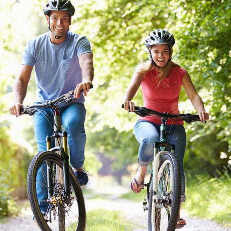 smile man and women ride cycling on the mountain